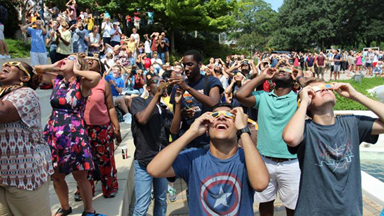 Georgia Tech students observing the almost total solar eclipse around the campanile